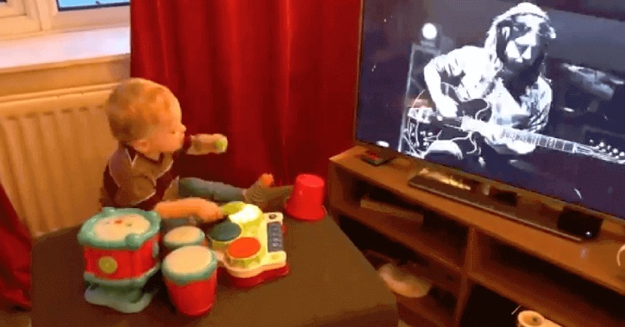 Kid plays the drums while sees Dave Grohl