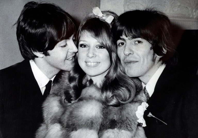 Paul McCartney and George Harrison with a girl