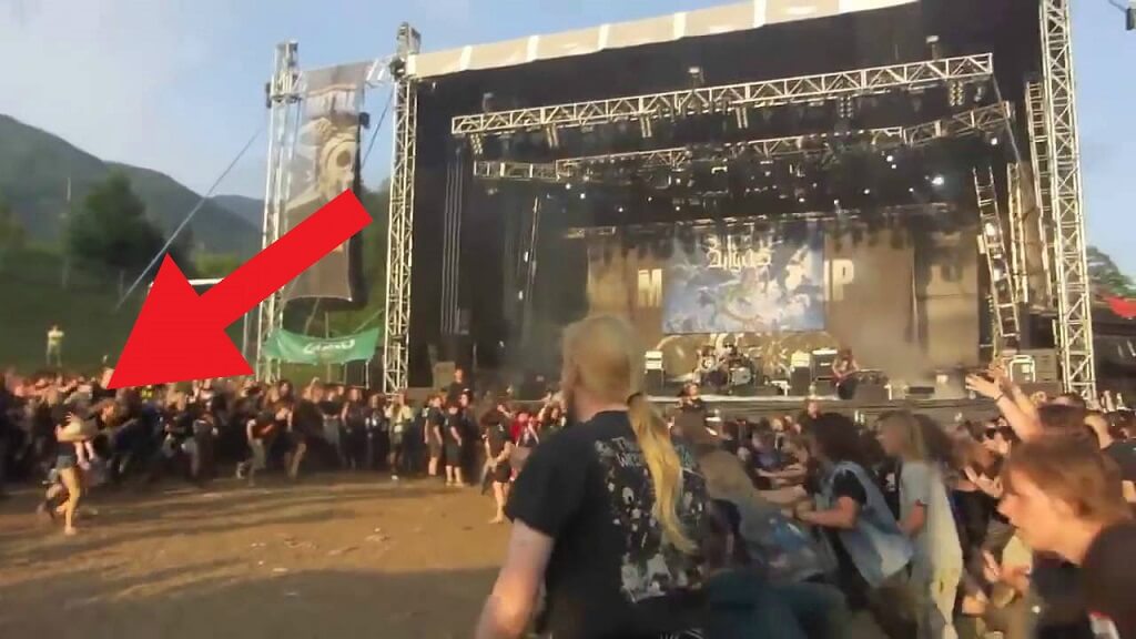 Woman takes baby Into a Wall of Death at Metal Concert