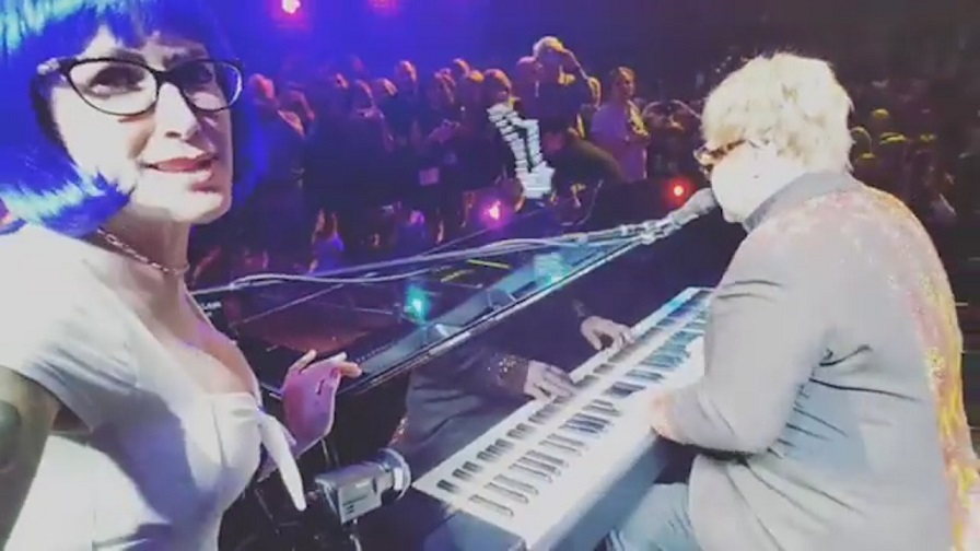 Watch Elton John being hit by a necklace during a show