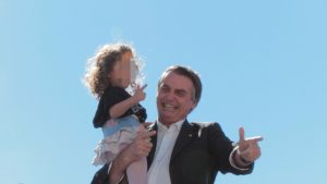 Jair Bolsonaro and little girl gun hand