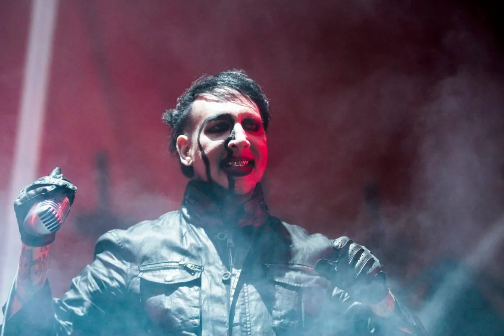 Manson reveals he broke his leg in two places and the reschedules dates