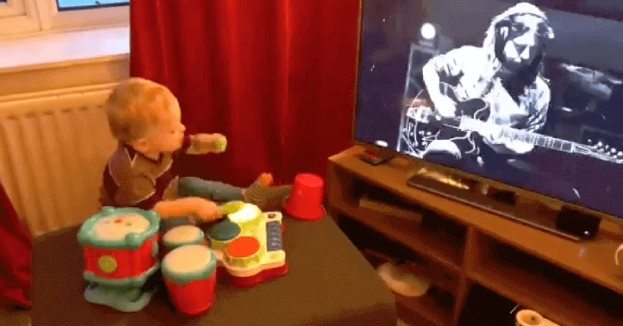 Kid plays the drums while sees Dave Grohl