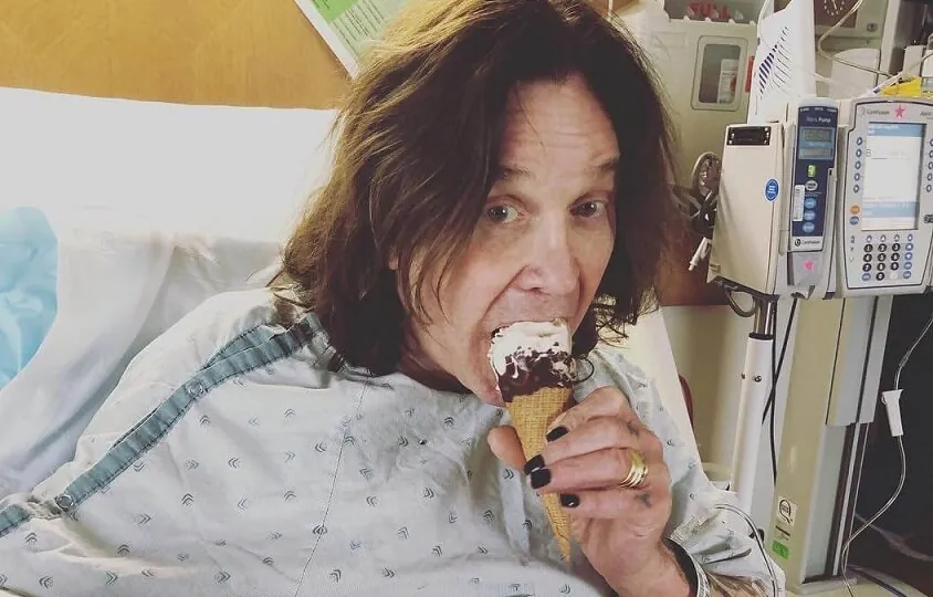 Ozzy Osbourne taking ice cream in the hospital